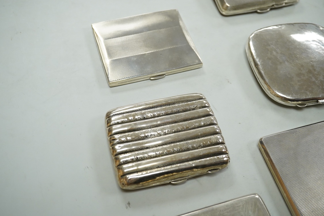 Nine assorted silver cigarette cases, including an Edwardian ribbed case and an engine turned rectangular case by Garrard & Co, Birmingham, 1960, 12.7cm, 32.1oz and one other unmarked white metal cigarette case.